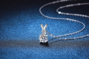 Macro shot of 925 sterling silver rabbit ear pendant with sparkling 1ct moissanite stones