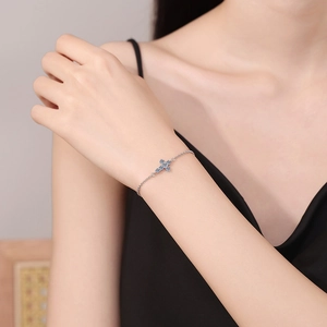 Elegant s925 sterling silver cross bracelet with D color moissanite on female wrist