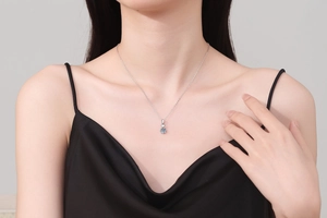 Elegant 1 carat moissanite heart pendant on a S925 sterling silver chain worn by a model