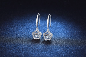 Macro shot of 925 silver plum blossom earrings with a dancing Moissanite center stone