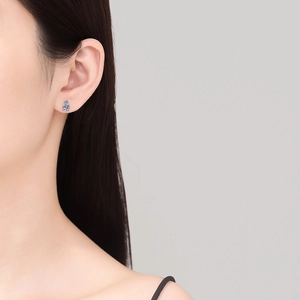 Classic S925 sterling silver four-prong Moissanite stud earrings on female model