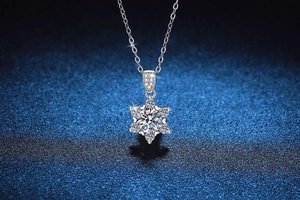 Close-up of snowflake pendant necklace with large central moissanite in 925 silver
