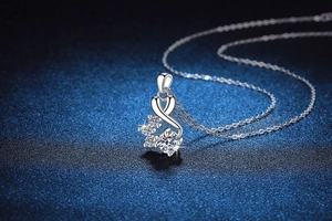 Close-up of a 925 sterling silver necklace featuring a sparkling moissanite infinity pendant