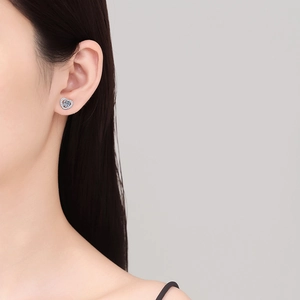 Sparkling S925 sterling silver heart stud earrings with moissanite on female model