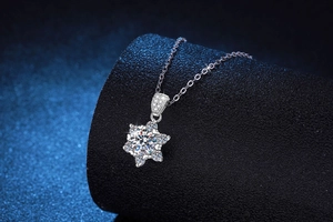 Macro detail of snowflake moissanite pendant on silver chain with cold blue lighting