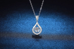Macro shot of s925 silver pear-shaped pendant with a floating round cut moissanite stone