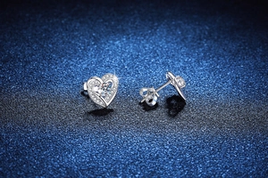 Macro shot of S925 silver heart stud earrings with sparkling round moissanite stones