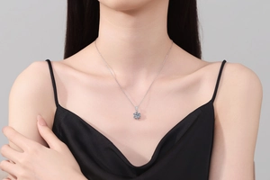 Detail of snowflake pendant necklace on model with sparkling 1 carat moissanite center