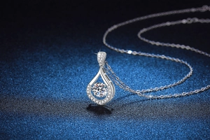 Detail of S925 sterling silver necklace with a dancing teardrop moissanite pendant