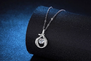 Macro shot of S925 silver teardrop pendant necklace with a brilliant round moissanite