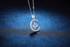 Close-up of S925 sterling silver moon and star pendant with sparkling moissanite stones
