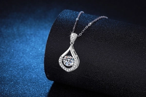 Close-up of teardrop 925 silver necklace with dancing round moissanite center stone