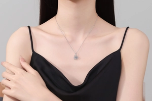 Detail view of s925 sterling silver necklace with moving moissanite pendant on a model