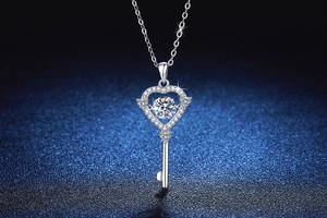 Macro detail of dancing heart key pendant in S925 silver with sparkling moissanite