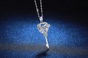 Macro detail of S925 sterling silver heart key pendant with sparkling moissanite stone