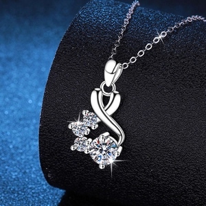 925 sterling silver necklace with 1 carat moissanite ribbon pendant on a black stand