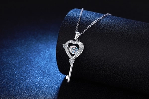 Detailed view of S925 silver heart-shaped key pendant with moissanite on display stand