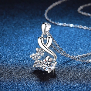 925 silver S-shaped necklace with 1 carat moissanite pendant on blue textured backdrop