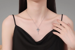 Close-up of S925 silver heart key pendant with 1ct moissanite on model neck
