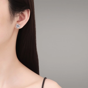 Minimalist S925 silver heart stud earrings with sparkling moissanite on model ear