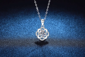Close-up of S925 sterling silver four-leaf clover pendant with round moissanite stone