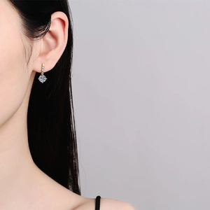 1ct moissanite drop earrings in 925 sterling silver worn by a model in a side view
