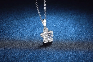 Macro shot of a S925 silver camellia flower pendant with sparkling moissanite stones