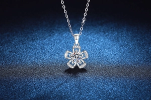 Detailed macro view of a floral S925 silver pendant featuring a sparkling moissanite stone
