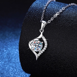 S925 sterling silver heart necklace with a brilliant round moissanite on black stand
