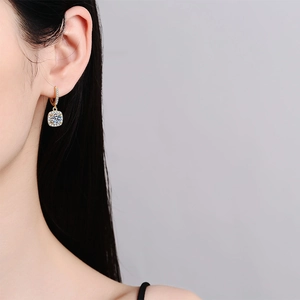 Elegant 14k gold square moissanite drop earrings worn by a model in a high-fashion portrait