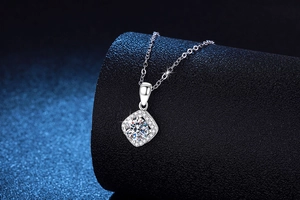 Macro shot of 1ct D color moissanite halo pendant in s925 silver with a diamond-cut main stone