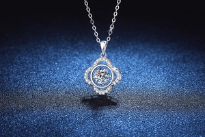 Macro detail of dancing moissanite pendant in S925 sterling silver clover frame