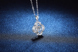 Macro shot of S925 sterling silver four-leaf clover pendant with dancing moissanite