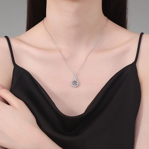 S925 sterling silver crown necklace with a dancing moissanite pendant on a model