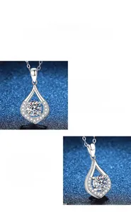 Detailed view of teardrop moissanite pendant with halo setting on a delicate silver chain