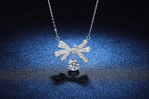 Macro shot of S925 silver necklace with brilliant bow pendant and 2ct moissanite gemstone