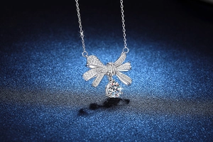 Close-up of S925 sterling silver bow pendant with 2-carat Moissanite and micro-pave setting