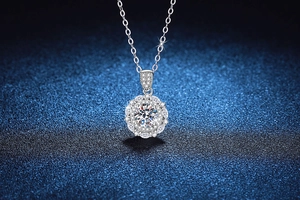 Macro shot of 1ct Moissanite starburst pendant with brilliant fire and silver chain