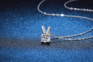 Detailed macro view of S925 silver necklace with rabbit ear moissanite pendant