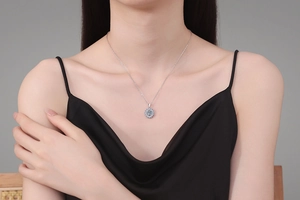 Close-up of S925 sterling silver necklace with a 1-carat moissanite pendant on a model