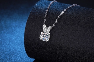 Macro detail of S925 silver moissanite pendant with rabbit ear design and sparkling stone