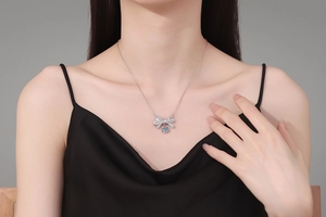 Macro shot of 925 sterling silver bow pendant featuring a brilliant blue moissanite gemstone