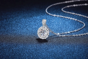 Close-up of flower halo moissanite pendant on silver chain over starry blue background