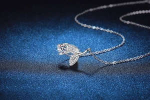 Macro shot of 925 sterling silver rose pendant with moissanite and pave setting