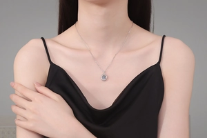 Close-up of S925 sterling silver moving heart necklace with 1 carat moissanite on neck