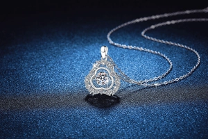 Detail showing dancing moissanite stone in a floral S925 sterling silver pendant