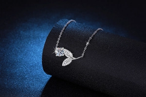 Macro detail of leaf-shaped sterling silver pendant with 1ct moissanite gemstone