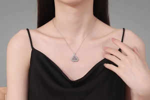 Detail of S925 sterling silver gourd pendant with sparkling 1 carat moissanite on a model