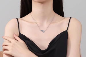 Close-up of 925 sterling silver leaf pendant necklace with moissanite on model
