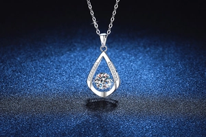Close-up of teardrop moissanite pendant with dancing stone in S925 sterling silver